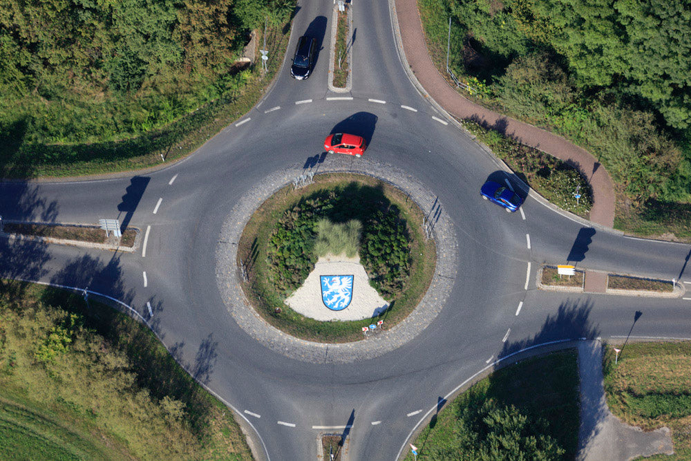 Roundabout with coat of arms and red car
