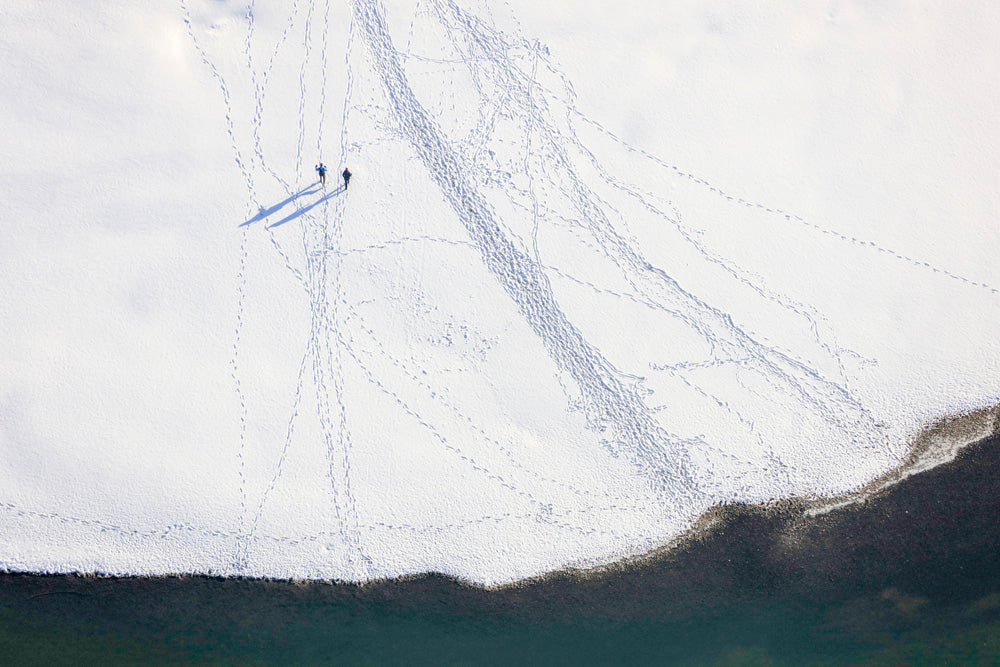 Two walkers in the snow on the Danube embankment