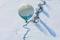 Hot air balloon over winter landscape
