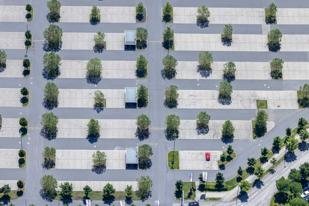 Red car in a parking lot on Sunday 