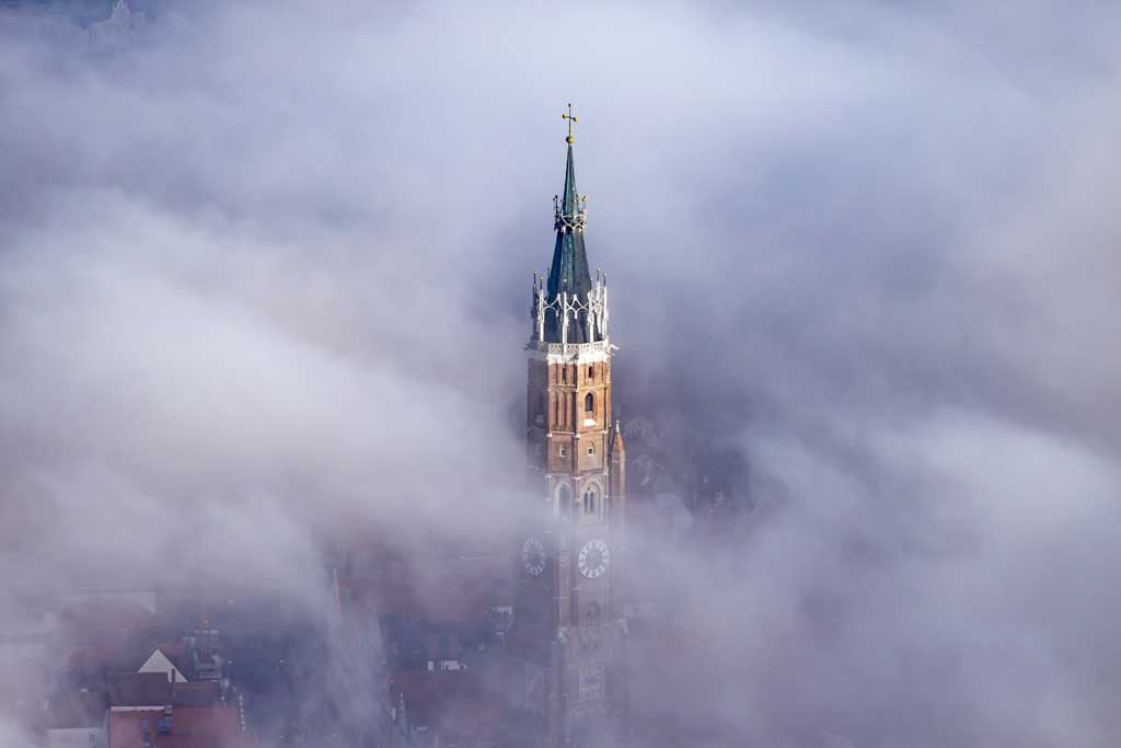 The church tower of St. Martin's Church is shrouded in fog. 
