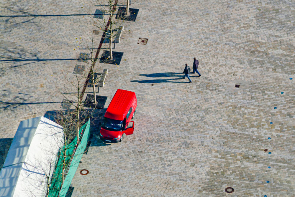 Two pedestrians and a red van